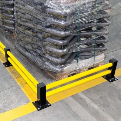 BLACK BULL Bodenbarriere ECO Querbalken doppelt gelb auf Betonboden neben Palette mit gestapelter, folierter Ware im Lager.